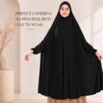 A woman wearing a jersey Hajj Umrah Scarf with Sleeves, providing full coverage for the head, neck, and shoulders without pins. By CLOTHIFYDOTPK