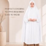A woman wearing a white jersey Hajj Umrah Scarf with Sleeves, providing full coverage for the head, neck, and shoulders without pins. By CLOTHIFYDOTPK