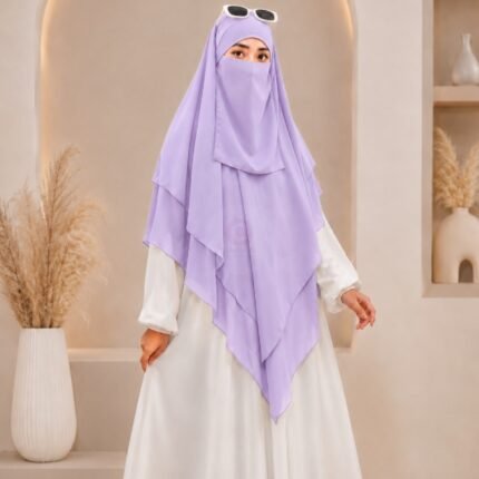 A woman wearing a three layer khimar hijab, with the first layer covering her head and draping down over her chest, and two additional sheer or lightweight layers cascading underneath. BY CLOTHIFYDOTPK