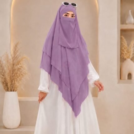 A woman wearing a three layer khimar, with the first layer covering her head and draping down over her chest, and two additional sheer or lightweight layers cascading underneath. BY CLOTHIFYDOTPK