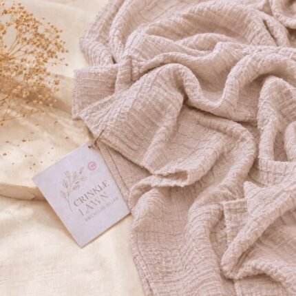 Close-up of sandstone crinkle lawn hijab fabric showing fine permanent pleats and lightweight weave. BY CLOTHIFYDOTPK