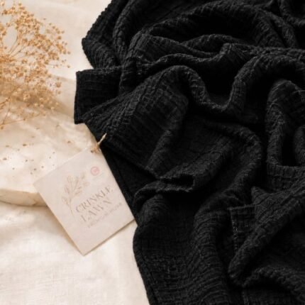Close-up of black crinkle lawn hijab fabric showing fine permanent pleats and lightweight weave. BY CLOTHIFYDOTPK