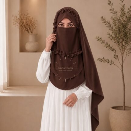 A woman wearing a soft, Chiffon instant Crown hijab with Niqab, draped smoothly around her head and shoulders with no visible pins. BY CLOTHIFYDOTPK