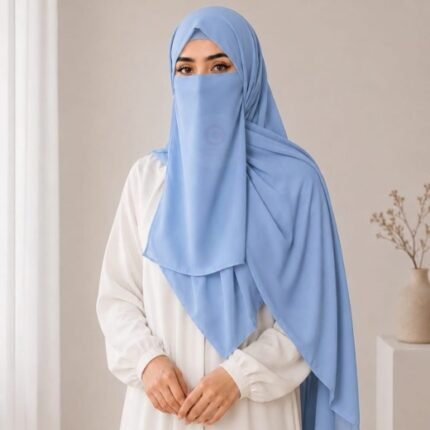 A woman wearing a complete 3 piece hijab set with a niqab covering her face, leaving only eyes visible. The set includes an underscarf, outer scarf and separate niqab. By CLOTHIFYDOTPK