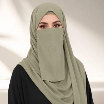 A woman wearing a complete three piece hijab set with a niqab covering her face, leaving only eyes visible. The set includes an underscarf, outer scarf and separate niqab. By CLOTHIFYDOTPK