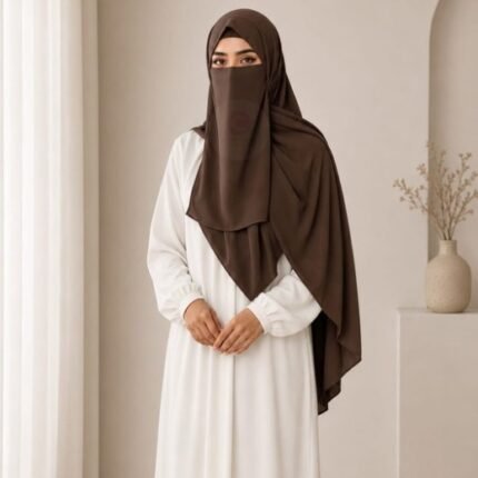 A woman wearing a complete 3 piece hijab set with a niqab covering her face, leaving only eyes visible. The set includes an underscarf, outer scarf and separate niqab. By CLOTHIFYDOTPK