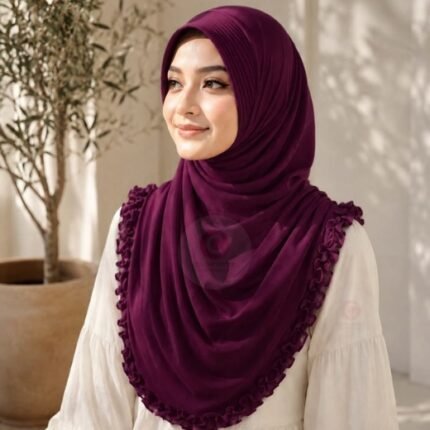 A woman wearing a soft, stretchy instant hijab, draped smoothly around her head and shoulders with no visible pins or wrapping layers.