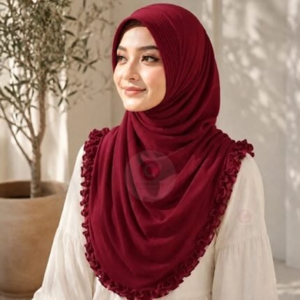 A woman wearing a soft, stretchy fancy instant hijab, draped smoothly around her head and shoulders with no visible pins or wrapping layers.