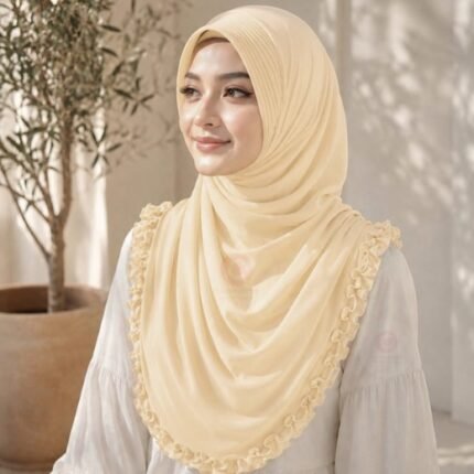 A woman wearing a soft, stretchy instant hijab, draped smoothly around her head and shoulders with no visible pins or wrapping layers.