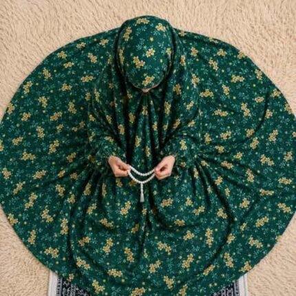 Young girl wearing a floral printed namaz chadar while praying on a mat. BY CLOTHIFYDOTPK