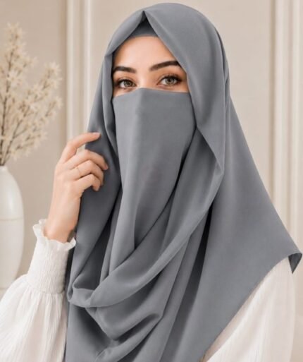 A woman wearing an elegant Instant Misri hijab set draped over the head and shoulders with attached Niqab for casual and formal occasions. By Clothifydotpk