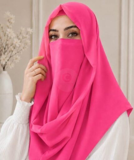 A woman wearing a punch pink color Misri hijab draped over the head and shoulders with attached Niqab. BY CLOTHIFYDOTPK