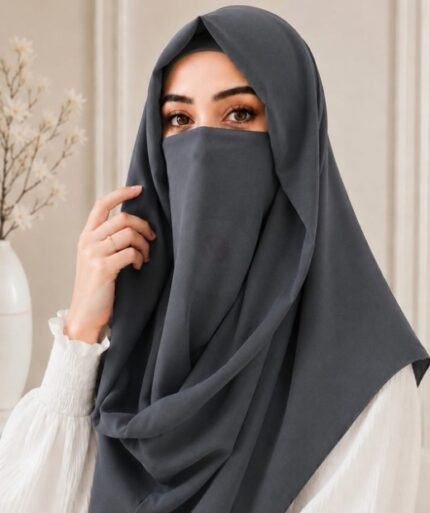 A woman wearing an elegant Misri style hijab set draped over the head and shoulders with attached Niqab for casual and formal occasions. By Clothifydotpk
