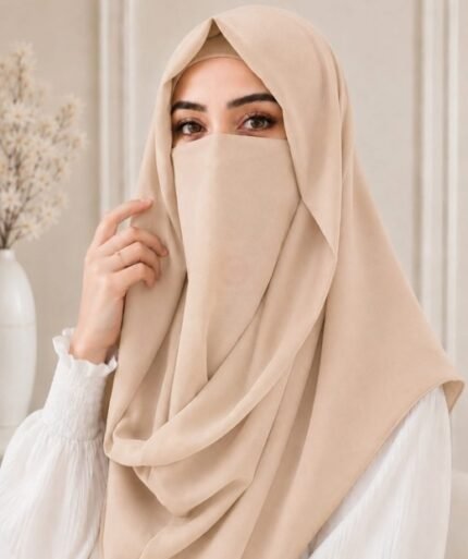 A woman wearing an elegant Misri style hijab set draped over the head and shoulders with attached Niqab for casual and formal occasions. By Clothifydotpk