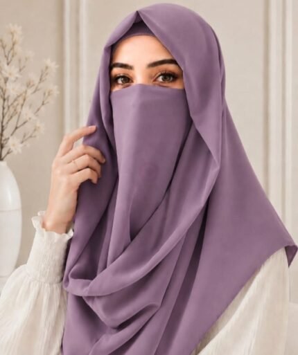 A woman wearing an elegant Instant Misri hijab set draped over the head and shoulders with attached Niqab for casual and formal occasions. By Clothifydotpk