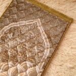 This beautifully designed, quilted prayer mat offers premium padding and is shown flat - courtesy of CLOTHIFYDOTPK.