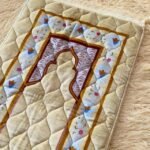 This beautifully designed, quilted prayer mat offers premium padding and is shown flat - courtesy of CLOTHIFYDOTPK.