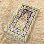 This beautifully designed, quilted prayer mat offers premium padding and is shown flat - courtesy of CLOTHIFYDOTPK.
