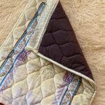 This beautifully designed, quilted prayer mat offers premium padding and is shown flat - courtesy of CLOTHIFYDOTPK.