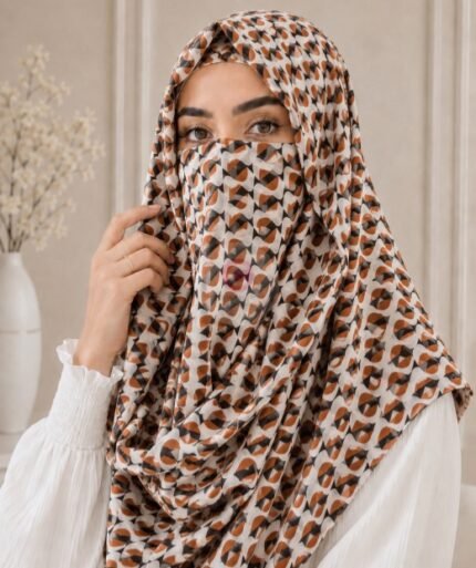 A woman wearing a Printed Misri hijab draped over the head and shoulders with attached Niqab. BY CLOTHIFYDOTPK