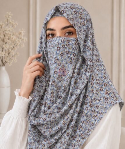 A woman wearing a Printed Misri hijab draped over the head and shoulders with attached Niqab. BY CLOTHIFYDOTPK
