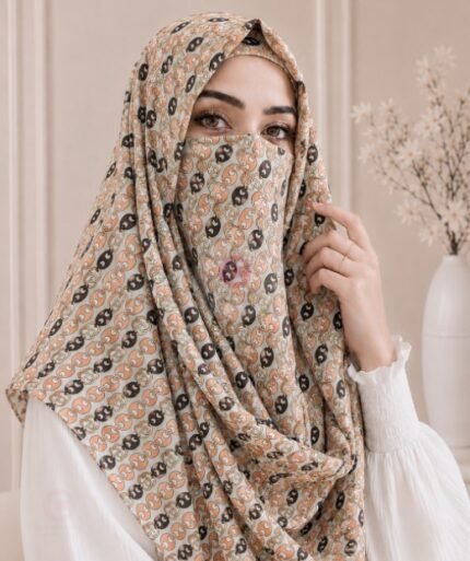 A woman wearing a Printed Misri hijab draped over the head and shoulders with attached Niqab. BY CLOTHIFYDOTPK