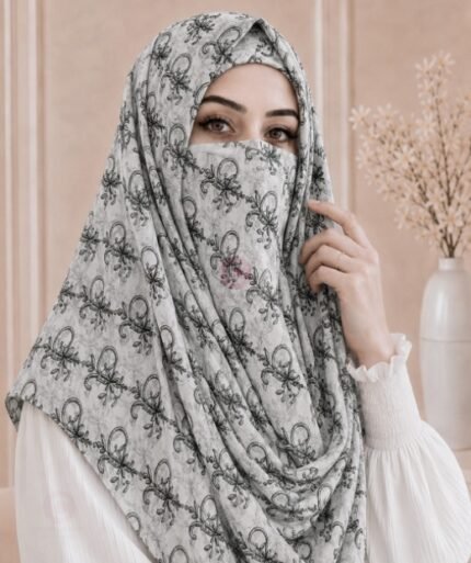 A woman wearing a Printed Misri hijab draped over the head and shoulders with attached Niqab. BY CLOTHIFYDOTPK