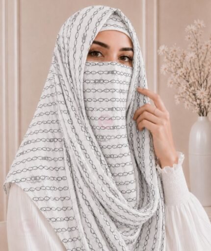 A woman wearing a Printed Misri hijab draped over the head and shoulders with attached Niqab. BY CLOTHIFYDOTPK