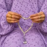Woman wearing full length printed arabic namaz chadar holding prayer beads. BY CLOTHIFYDOTPK
