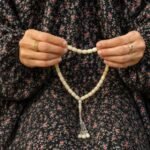 Woman wearing full length printed arabic namaz chadar holding prayer beads. BY CLOTHIFYDOTPK