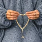 Woman wearing full length printed arabic namaz chadar holding prayer beads. BY CLOTHIFYDOTPK