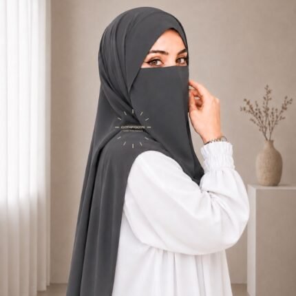 A woman wearing a complete two piece hijab set with a niqab covering her face, leaving only eyes visible. The set includes an Hijab and separate niqab. By CLOTHIFYDOTPK