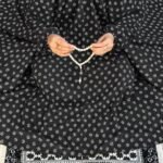 A woman performing Salah comfortably in a breathable, soft Swiss lawn Namaz Chadar with sleeves- available at CLOTHIFYDOTPK