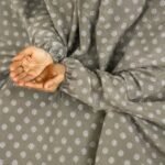 A woman performing Salah comfortably in a breathable, soft Swiss lawn Namaz Chadar with sleeves- available at CLOTHIFYDOTPK