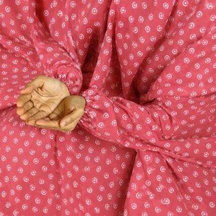 A woman performing Salah comfortably in a breathable, soft Swiss lawn Namaz Chadar with sleeves- available at CLOTHIFYDOTPK