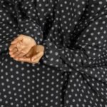 A woman performing Salah comfortably in a breathable, soft Swiss lawn Namaz Chadar with sleeves- available at CLOTHIFYDOTPK