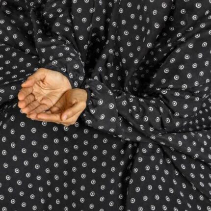 A woman performing Salah comfortably in a breathable, soft Swiss lawn Namaz Chadar with sleeves- available at CLOTHIFYDOTPK