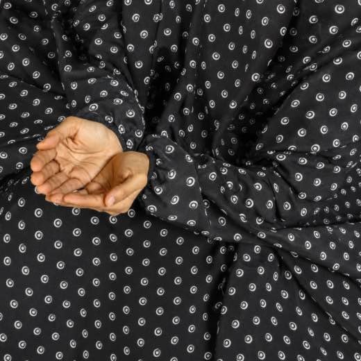 A woman performing Salah comfortably in a breathable, soft Swiss lawn Namaz Chadar with sleeves- available at CLOTHIFYDOTPK