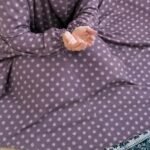 A woman performing Salah comfortably in a breathable, soft Swiss lawn Namaz Chadar with sleeves- available at CLOTHIFYDOTPK