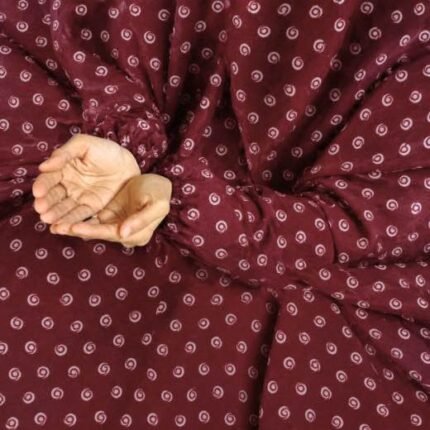 A woman performing Salah comfortably in a breathable, soft Swiss lawn Namaz Chadar with sleeves- available at CLOTHIFYDOTPK