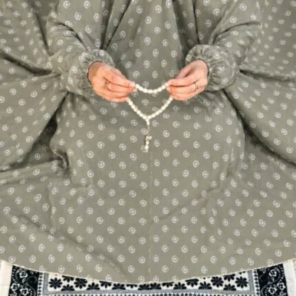A woman performing Salah comfortably in a breathable, soft Swiss lawn Namaz Chadar with sleeves- available at CLOTHIFYDOTPK