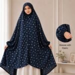 A woman standing for Salah comfortably in a breathable, soft Swiss lawn Namaz Chadar with sleeves- available at CLOTHIFYDOTPK