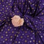 A woman wearing breathable soft swiss lawn modest coverage Namaz Chadar with sleeves, performing salah. By Clothifydotpk
