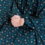 A woman wearing breathable soft swiss lawn modest coverage Namaz Chadar with sleeves, performing salah. By Clothifydotpk