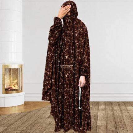 A woman using a breathable soft swiss lawn full coverage Namaz Chadar with sleeves, performing salah By Clothifydotpk