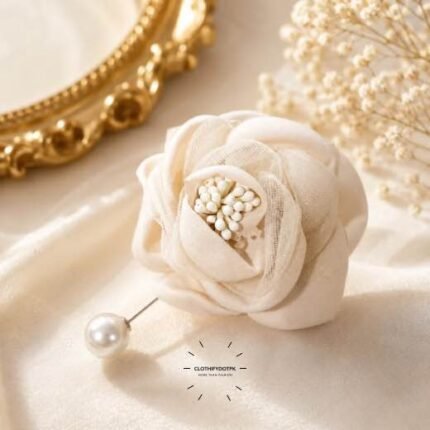 Hand-stitched flower shape brooch with layered petals and a pearl pin clasp.