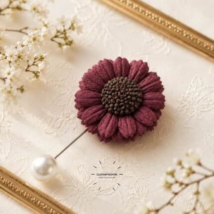 Hand-stitched flower shape brooch with petals and a pearl pin clasp.