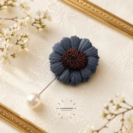 Hand-stitched flower shape brooch with petals and a pearl pin clasp.