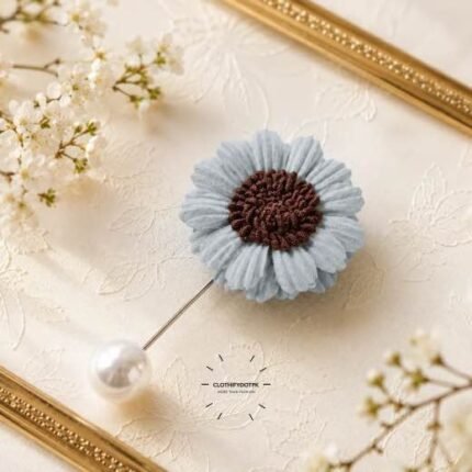 Hand-stitched flower shape brooch with petals and a pearl pin clasp.