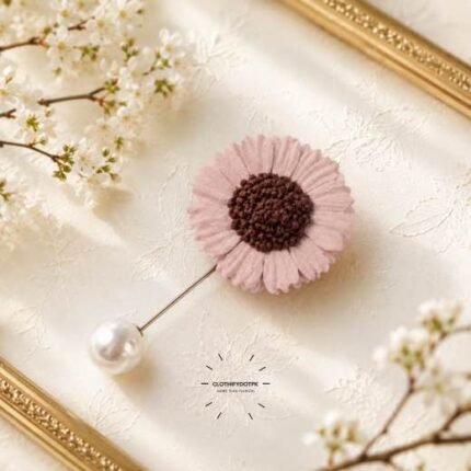 Hand-stitched flower shape brooch with petals and a pearl pin clasp.